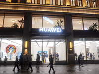 Pedestrians walk past Huawei's global flagship store in Shanghai, China, on October 15, 2024. (