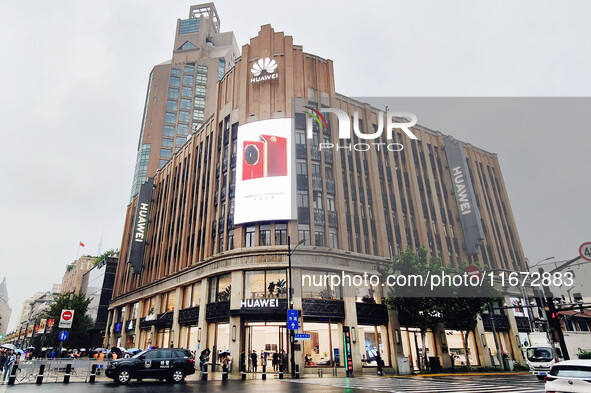 Pedestrians walk past Huawei's global flagship store in Shanghai, China, on October 15, 2024. 