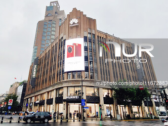 Pedestrians walk past Huawei's global flagship store in Shanghai, China, on October 15, 2024. (