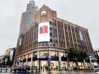 Pedestrians walk past Huawei's global flagship store in Shanghai, China, on October 15, 2024. (