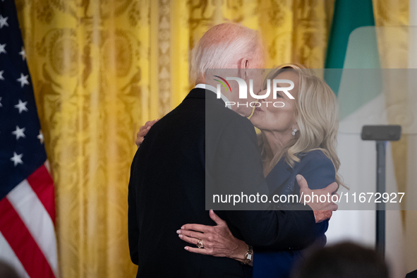 First Lady Dr. Jill Biden gives President Joe Biden a kiss on the cheek after introducing him to deliver remarks at a reception celebrating...