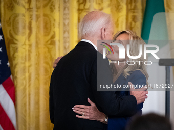 First Lady Dr. Jill Biden gives President Joe Biden a kiss on the cheek after introducing him to deliver remarks at a reception celebrating...