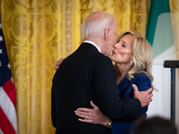 First Lady Dr. Jill Biden gives President Joe Biden a kiss on the cheek after introducing him to deliver remarks at a reception celebrating...