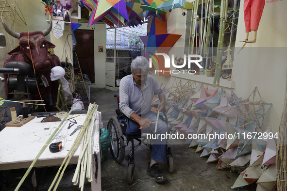 David Galicia, an artisan, repairs dolls and stars of the animas in Mexico City, Mexico, on October 16, 2024, made with this material and co...