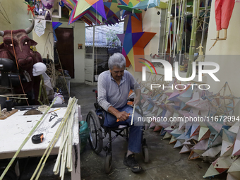 David Galicia, an artisan, repairs dolls and stars of the animas in Mexico City, Mexico, on October 16, 2024, made with this material and co...