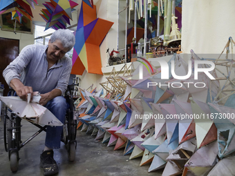 David Galicia, an artisan, repairs stars of the animas in Mexico City, Mexico, on October 16, 2024, made with this material and corn husks t...