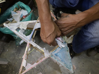 David Galicia, an artisan, repairs stars of the animas in Mexico City, Mexico, on October 16, 2024, made with this material and corn husks t...