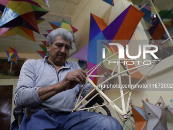 David Galicia, an artisan, repairs stars of the animas in Mexico City, Mexico, on October 16, 2024, made with this material and corn husks t...