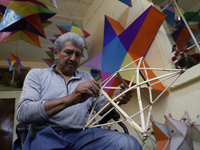 David Galicia, an artisan, repairs stars of the animas in Mexico City, Mexico, on October 16, 2024, made with this material and corn husks t...