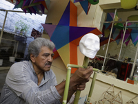 David Galicia, an artisan, repairs dolls and stars of the animas in Mexico City, Mexico, on October 16, 2024, made with this material and co...