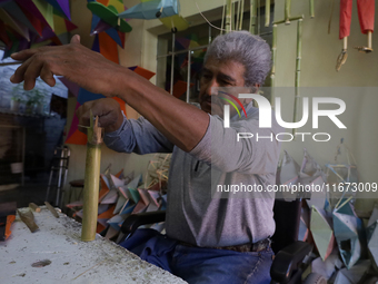 David Galicia, an artisan, cuts reeds for the repair, elaboration, and sale of stars of the animas in Mexico City, Mexico, on October 16, 20...