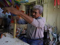 David Galicia, an artisan, cuts reeds for the repair, elaboration, and sale of stars of the animas in Mexico City, Mexico, on October 16, 20...