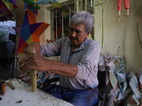 David Galicia, an artisan, cuts reeds for the repair, elaboration, and sale of stars of the animas in Mexico City, Mexico, on October 16, 20...