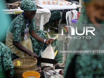 A woman cuts fish as the Lagos State Ministry of Agriculture and Food Systems concludes activities for the 2024 World Food Day, tagged Eko W...