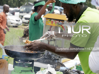 A man serves fried meat as the Lagos State Ministry of Agriculture and Food Systems concludes activities for the 2024 World Food Day, called...