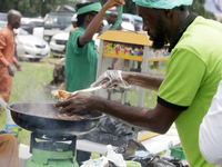 A man serves fried meat as the Lagos State Ministry of Agriculture and Food Systems concludes activities for the 2024 World Food Day, called...