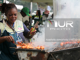 A woman prepares pork as the Lagos State Ministry of Agriculture and Food Systems concludes activities marking 2024 World Food Day, tagged E...