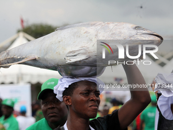 A farmer carries fish as the Lagos State Ministry of Agriculture and Food Systems concludes activities for the 2024 World Food Day, tagged E...