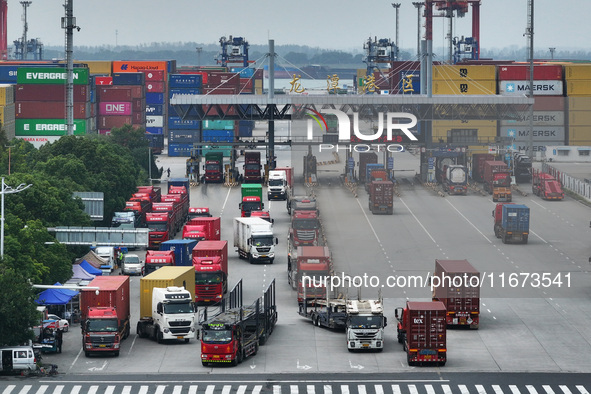 Trucks are seen at the Longtan Port area of Nanjing Port in Nanjing, Jiangsu province, China, on October 17, 2024. 