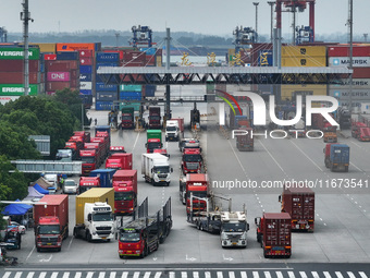 Trucks are seen at the Longtan Port area of Nanjing Port in Nanjing, Jiangsu province, China, on October 17, 2024. (