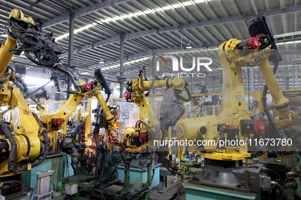 A robot makes auto parts at the production workshop of Zhenhua Zhende Auto Parts Co., Ltd. in Ningde, China, on October 17, 2024. 