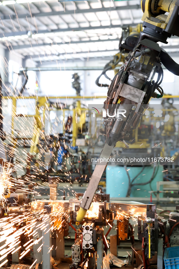 A robot makes auto parts at the production workshop of Zhenhua Zhende Auto Parts Co., Ltd. in Ningde, China, on October 17, 2024. 