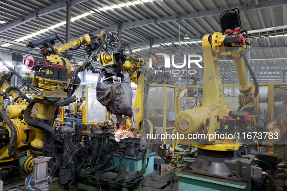 A robot makes auto parts at the production workshop of Zhenhua Zhende Auto Parts Co., Ltd. in Ningde, China, on October 17, 2024. 