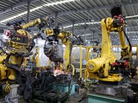 A robot makes auto parts at the production workshop of Zhenhua Zhende Auto Parts Co., Ltd. in Ningde, China, on October 17, 2024. (