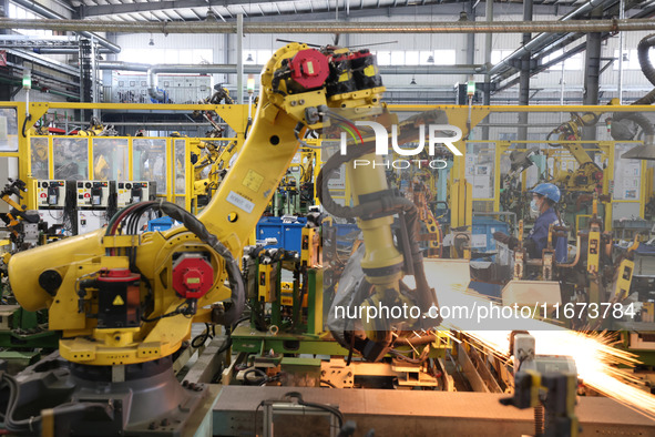 A robot makes auto parts at the production workshop of Zhenhua Zhende Auto Parts Co., Ltd. in Ningde, China, on October 17, 2024. 