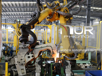 A worker makes auto parts at the production workshop of Zhenhua Zhende Auto Parts Co., Ltd. in Ningde, China, on October 17, 2024. (