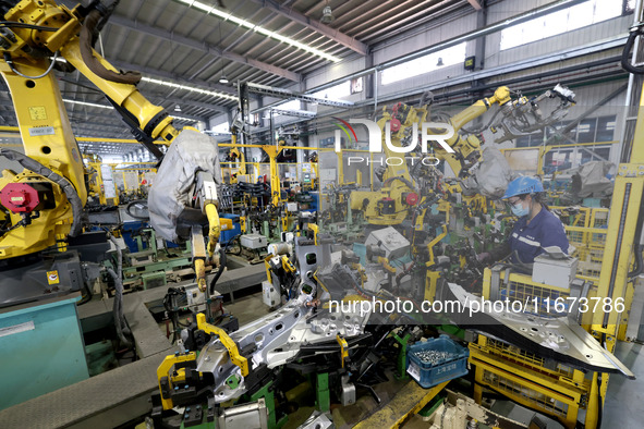 A worker makes auto parts at the production workshop of Zhenhua Zhende Auto Parts Co., Ltd. in Ningde, China, on October 17, 2024. 