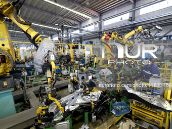 A worker makes auto parts at the production workshop of Zhenhua Zhende Auto Parts Co., Ltd. in Ningde, China, on October 17, 2024. (