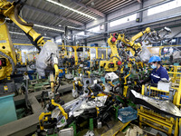 A worker makes auto parts at the production workshop of Zhenhua Zhende Auto Parts Co., Ltd. in Ningde, China, on October 17, 2024. (