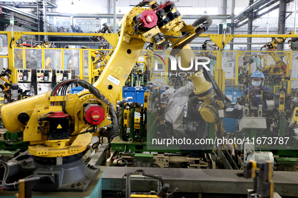 A worker makes auto parts at the production workshop of Zhenhua Zhende Auto Parts Co., Ltd. in Ningde, China, on October 17, 2024. 