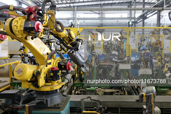 A worker makes auto parts at the production workshop of Zhenhua Zhende Auto Parts Co., Ltd. in Ningde, China, on October 17, 2024. 