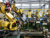 A worker makes auto parts at the production workshop of Zhenhua Zhende Auto Parts Co., Ltd. in Ningde, China, on October 17, 2024. (