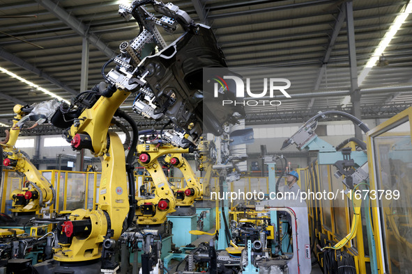 A worker makes auto parts at the production workshop of Zhenhua Zhende Auto Parts Co., Ltd. in Ningde, China, on October 17, 2024. 