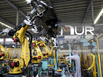 A worker makes auto parts at the production workshop of Zhenhua Zhende Auto Parts Co., Ltd. in Ningde, China, on October 17, 2024. (