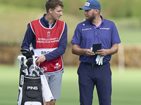 Daniel Brown of England talks with his caddie on the 14th hole on day one of the Estrella Damm N.A. Andalucia Masters 2024 at Real Club de G...