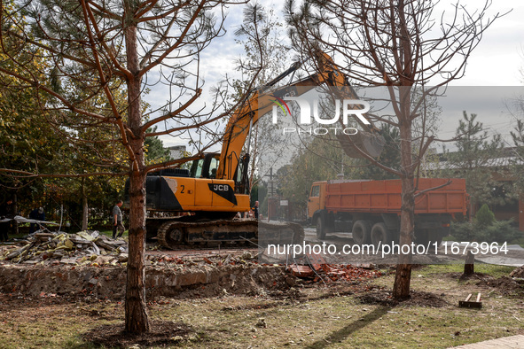 An excavator loads a truck with rubble near the Delta hotel and restaurant, which is damaged by a Russian drone attack in Vylkove, Ukraine,...