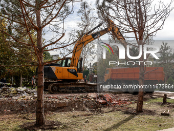 An excavator loads a truck with rubble near the Delta hotel and restaurant, which is damaged by a Russian drone attack in Vylkove, Ukraine,...