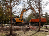 An excavator loads a truck with rubble near the Delta hotel and restaurant, which is damaged by a Russian drone attack in Vylkove, Ukraine,...