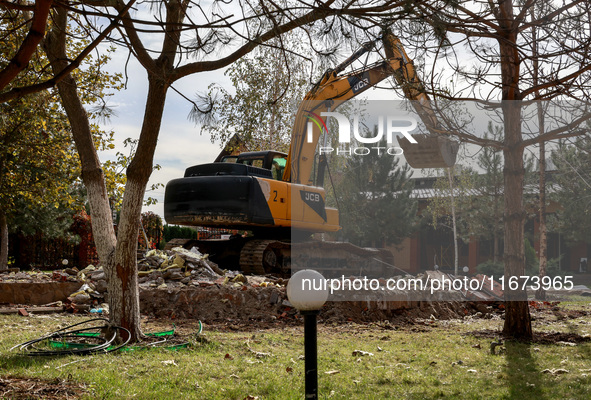 An excavator removes the rubble near the Delta hotel and restaurant damaged by a Russian drone attack in Vylkove, Ukraine, on October 11, 20...