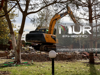 An excavator removes the rubble near the Delta hotel and restaurant damaged by a Russian drone attack in Vylkove, Ukraine, on October 11, 20...