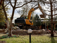 An excavator removes the rubble near the Delta hotel and restaurant damaged by a Russian drone attack in Vylkove, Ukraine, on October 11, 20...