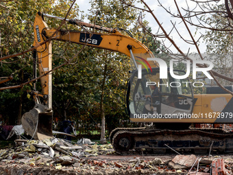 An excavator removes the rubble near the Delta hotel and restaurant damaged by a Russian drone attack in Vylkove, Ukraine, on October 11, 20...