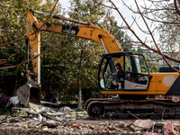 An excavator removes the rubble near the Delta hotel and restaurant damaged by a Russian drone attack in Vylkove, Ukraine, on October 11, 20...