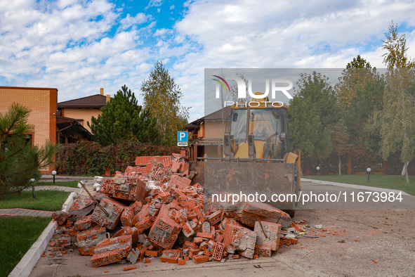 A tractor removes the rubble near the Delta hotel and restaurant damaged by a Russian drone attack in Vylkove, Ukraine, on October 11, 2024....