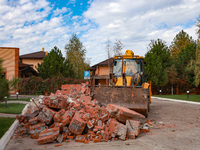 A tractor removes the rubble near the Delta hotel and restaurant damaged by a Russian drone attack in Vylkove, Ukraine, on October 11, 2024....