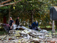 Workers clear away the rubble near the Delta hotel and restaurant damaged by a Russian drone attack in Vylkove, Ukraine, on October 11, 2024...